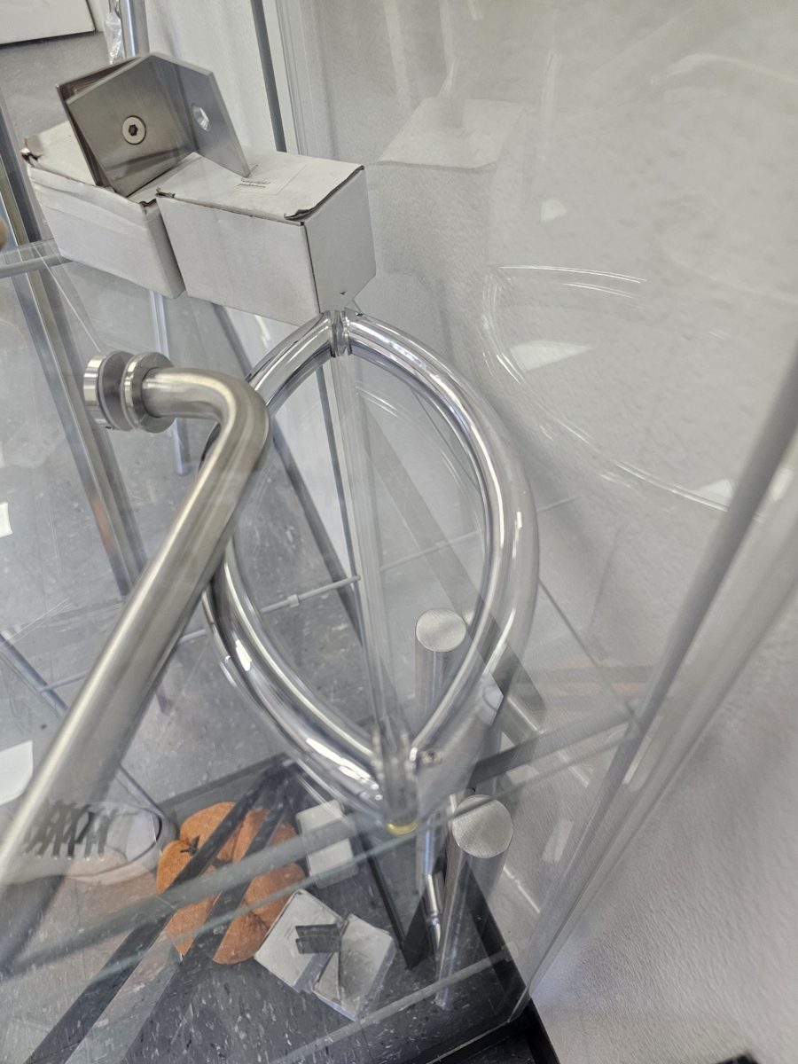 Chrome handles in a Glas Plus display case: an oval handle and a D-handle in a chrome finish