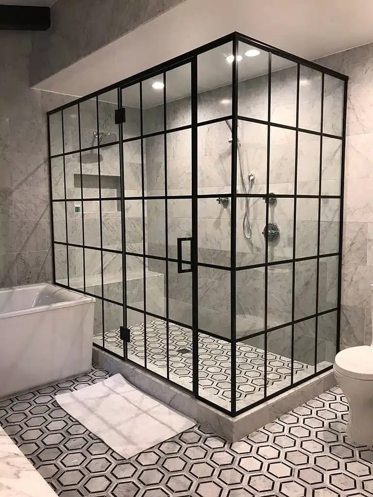 Glas Plus job: industrial style with a full black grid in a large shower next to a tub, with a hexagonal floor