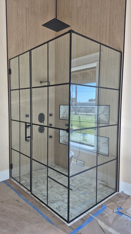 Glas Plus industrial-style bathroom example: full black frame and grid over all the shower glass