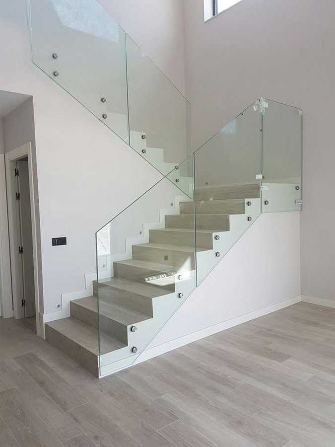Glas Plus staircases example: glass railing with chrome standoffs on a floating staircase