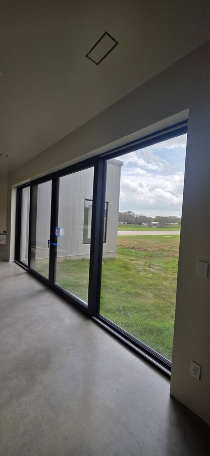 Glas Plus patio doors example: sliding patio door with large panels and a black frame, seen from inside