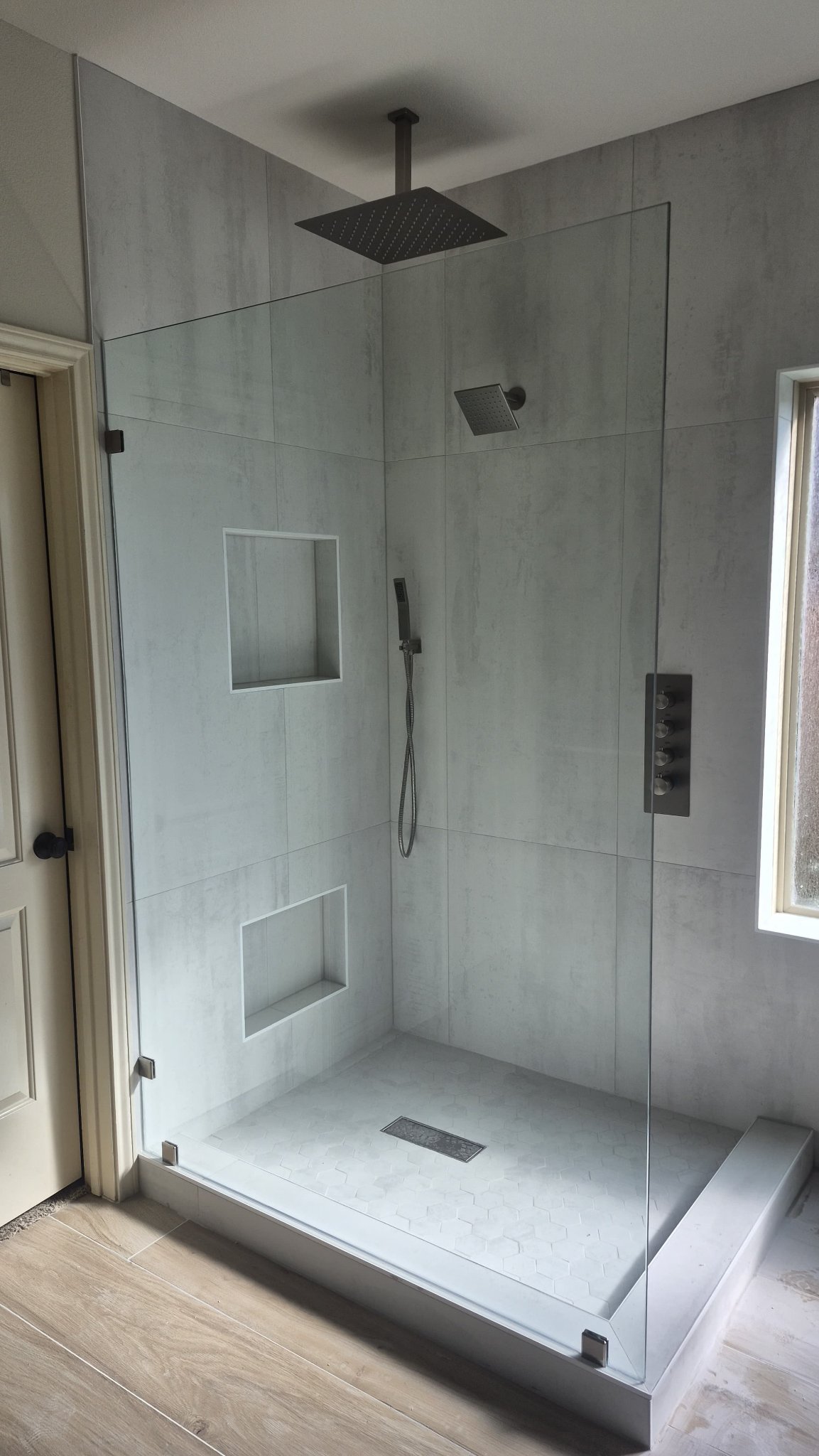 Glas Plus job: fixed glass panel with no door in an open shower