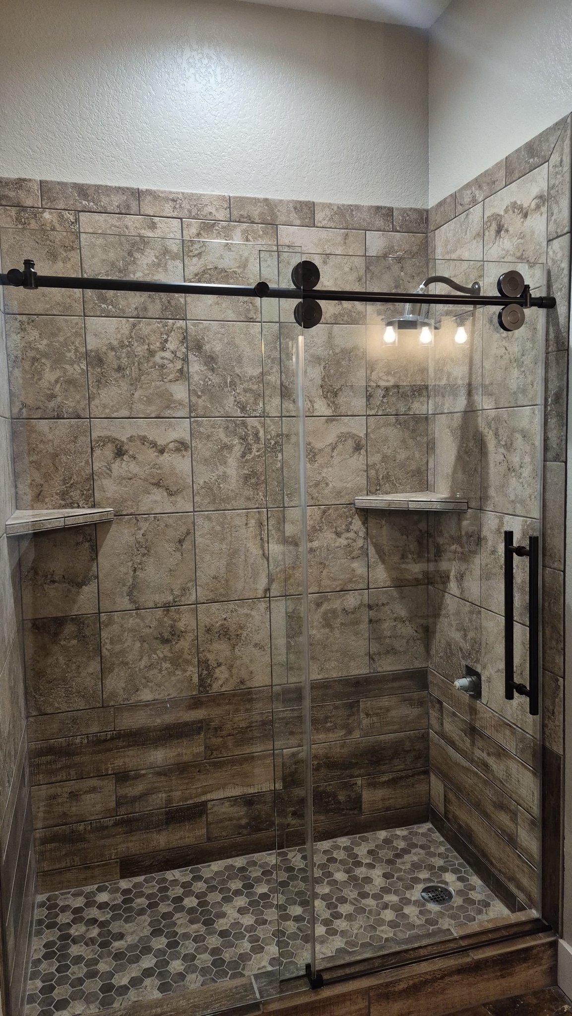 Soft-close sliding with black hardware and fixed panel installed by Glas Plus
